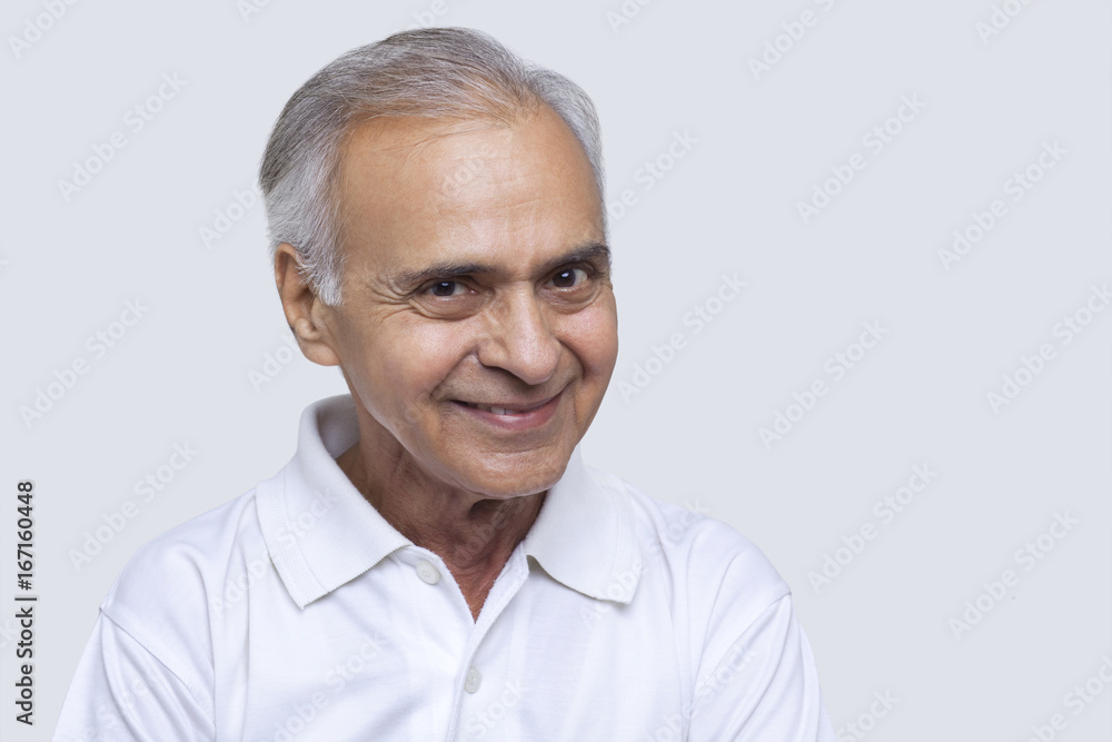 Portrait of man smiling over white background Portrait of man smiling over white background