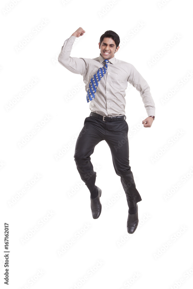 Portrait of a male executive jumping in the air Portrait of a male executive jumping in the air
