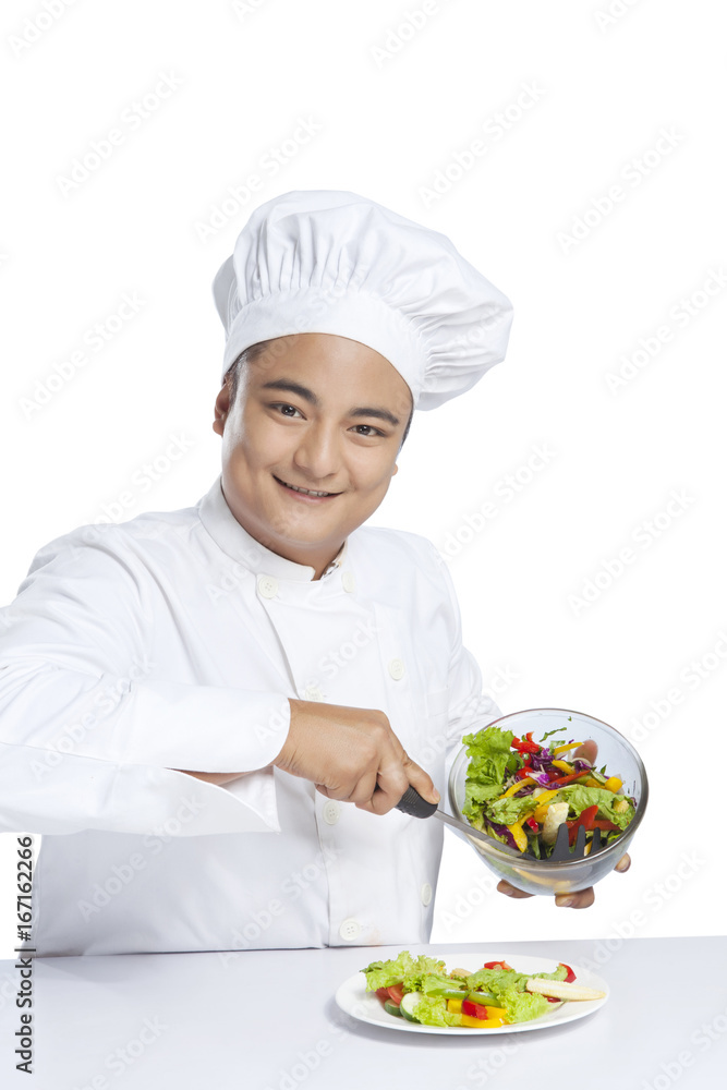 Portrait of chef serving vegetables on plate Portrait of chef serving vegetables on plate