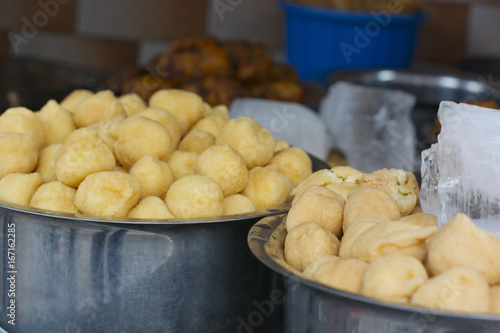 Close-up of vadas in containers at stall