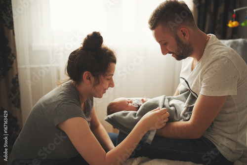 mother and father with newborn baby photo