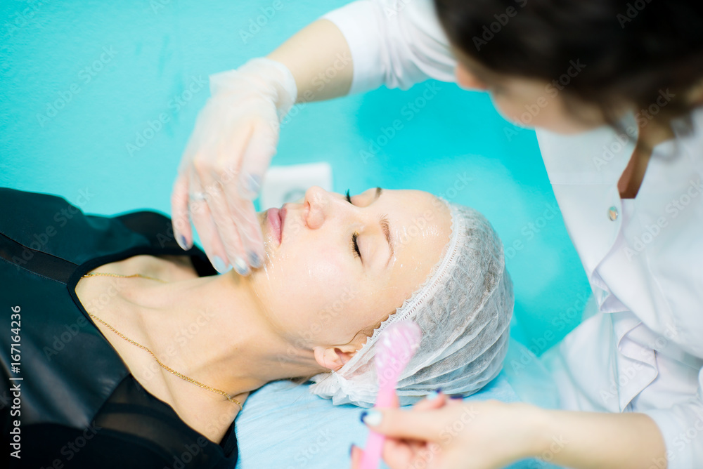 Doctor beautician cleansing face Doctor beautician cleansing face