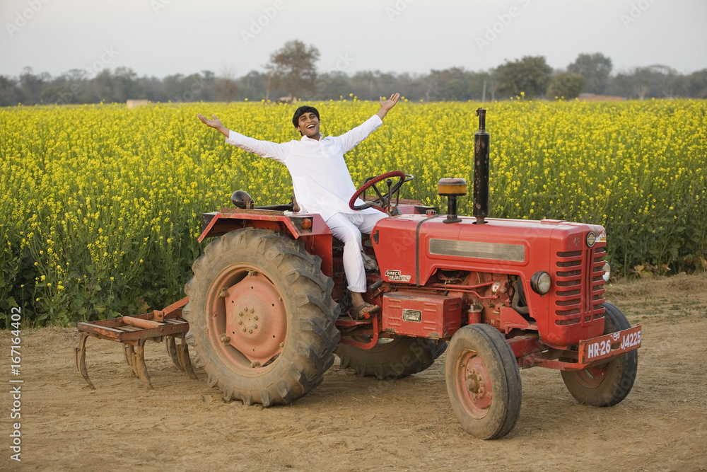 Fototapeta premium A farmer on his tractor 