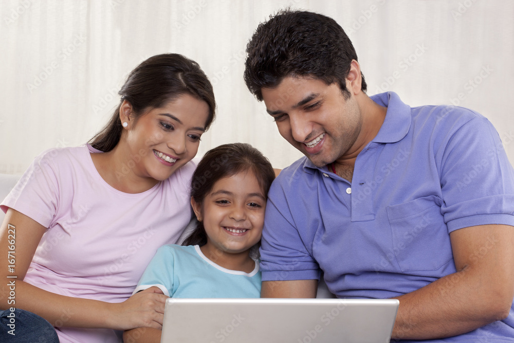 Happy family using laptop Happy family using laptop