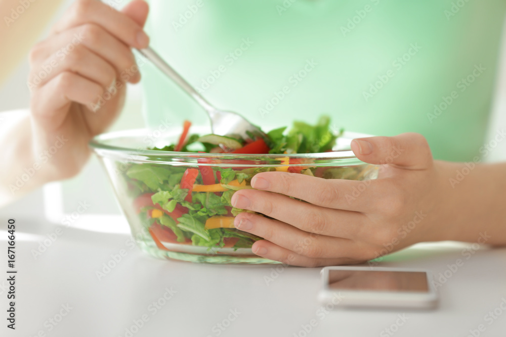 Young woman eating salad, closeup. Weight loss concept Young woman eating salad, closeup. Weight loss concept