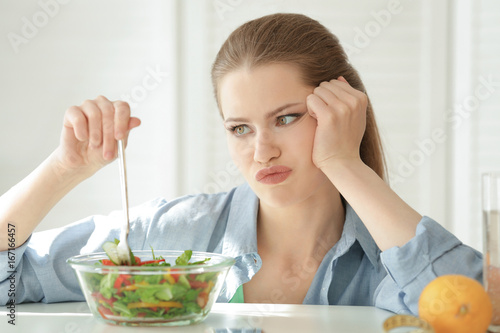 Young woman having breakfas...