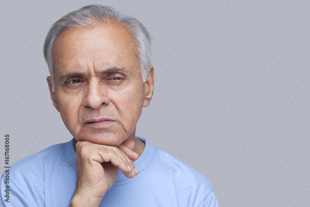 Close-up of senior man with hand on chin Close-up of senior man with hand on chin