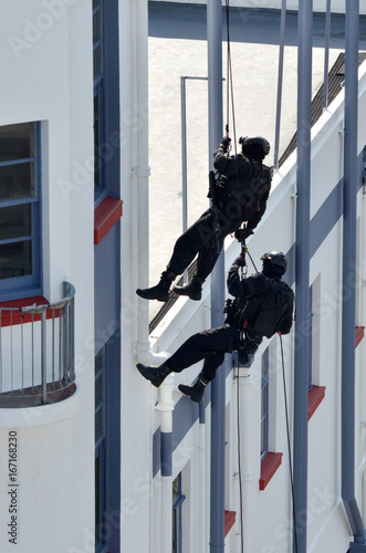Counter-terrorism police officers abseiling a building