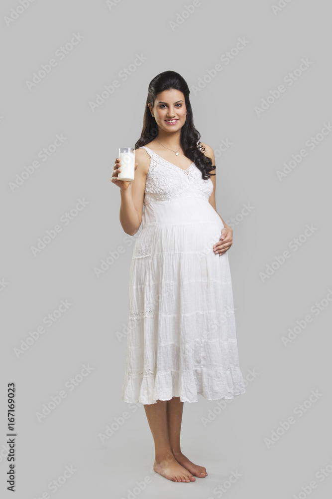 Portrait of a pregnant woman with a glass of milk Portrait of a pregnant woman with a glass of milk