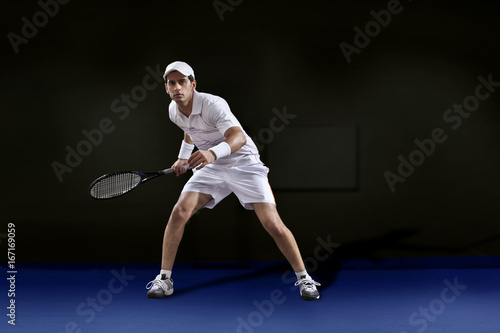 Full length of man in sportswear playing tennis at court © IndiaPix