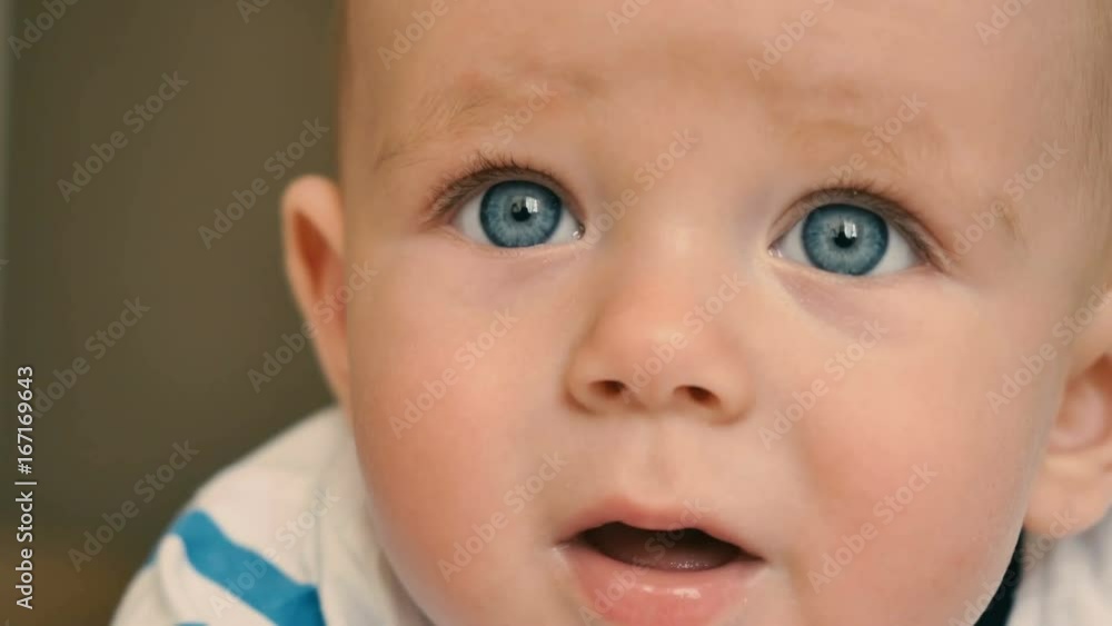 Portrait of cute blue-eyed baby is crying