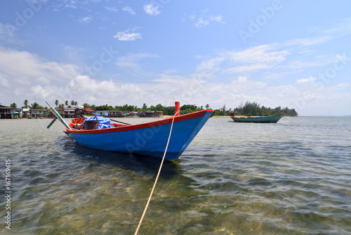 Small fishing boats anchored on the coast.