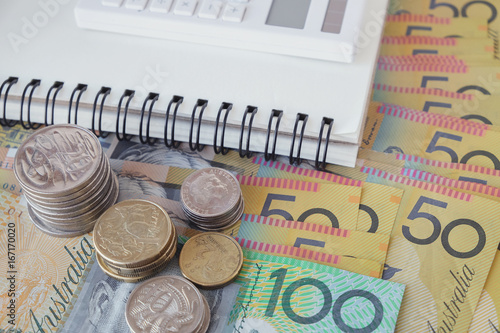 Australian money, AUD with calculator, notebook, donate, charity, household income, Coronavirus economic stimulus rescue package, superannuation concept photo