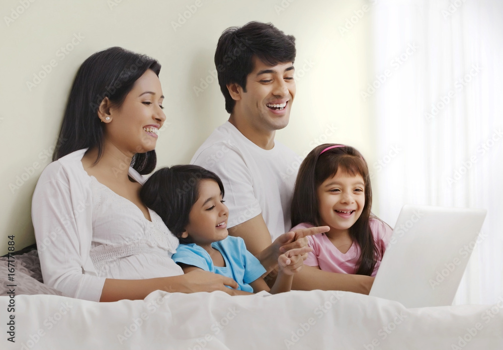 Family looking at laptop