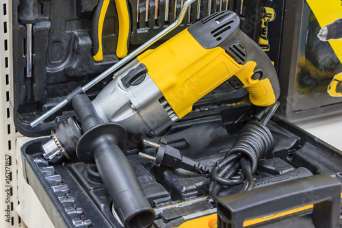 rotary hammer with a Hammer drill, screwdriver, Electric cordless hand drill in on the case, Maintenance concept