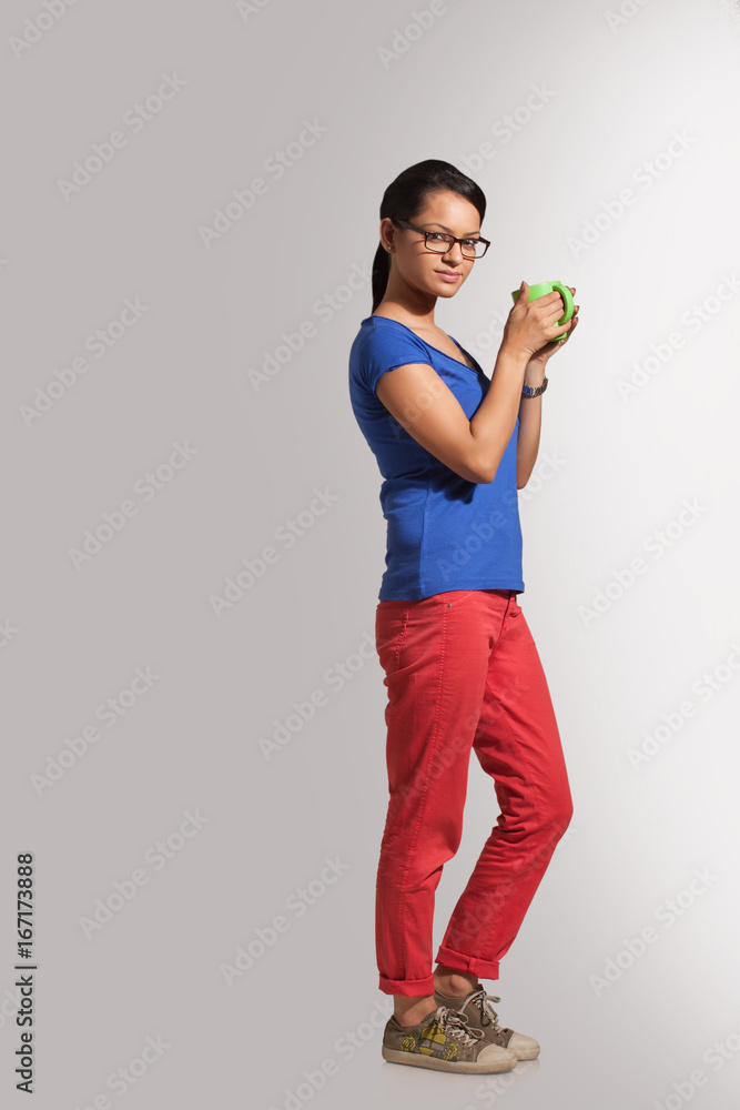 Portrait of a young woman with a mug of tea Portrait of a young woman with a mug of tea