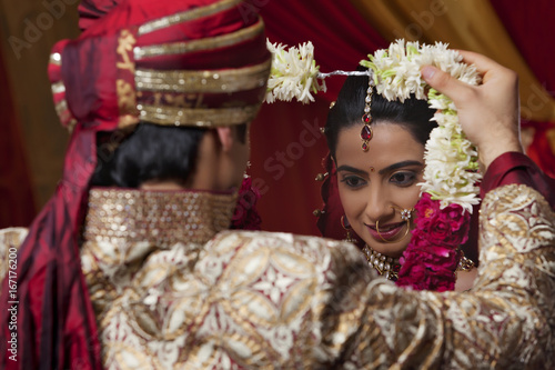 Close-up of young couple during wedding ceremony 