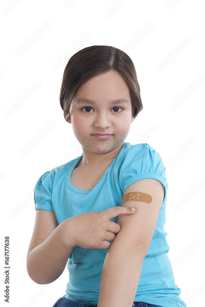 Portrait of little girl with band-aid on arm Portrait of little girl with band-aid on arm
