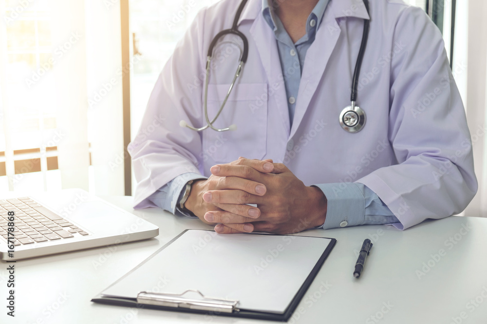 Close up of doctor filling up an history form while consulting patient and think about finding a cure for a diagnosis, treatment methods to rehabilitate the body Close up of doctor filling up an history form while consulting patient and think about finding a cure for a diagnosis, treatment methods to rehabilitate the body