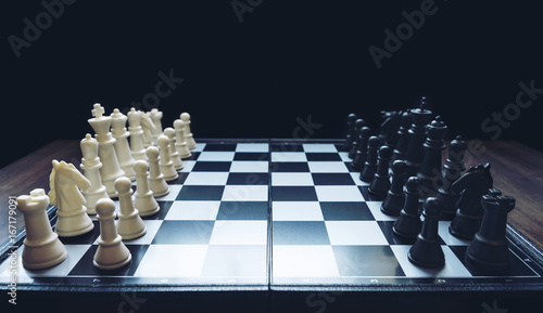 Fotografia Beginning of the game, Two chess teams in front of different color white and bla