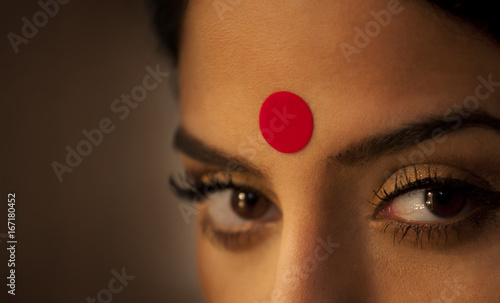 Close-up of eye and bindi of a woman  photo