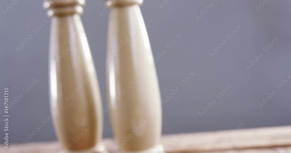 Hamburger with salt and pepper shakers on table Hamburger with salt and pepper shakers on table