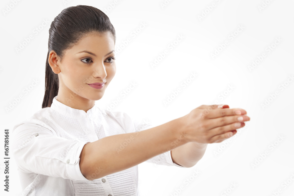 Close-up of woman with hands clasped doing yoga over white background Close-up of woman with hands clasped doing yoga over white background