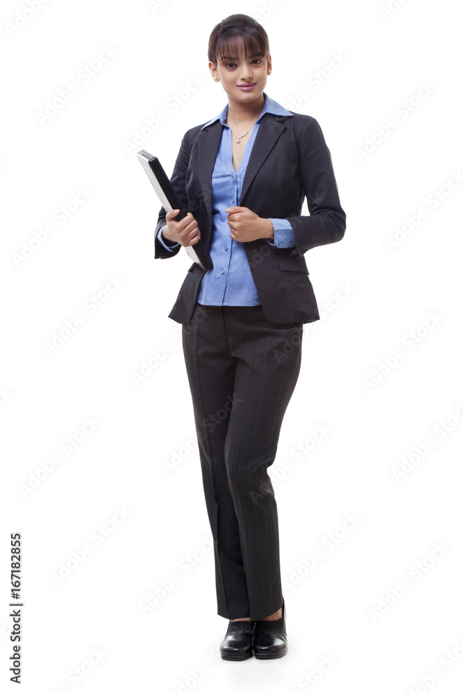 Full length of happy young businesswoman holding laptop over white background 