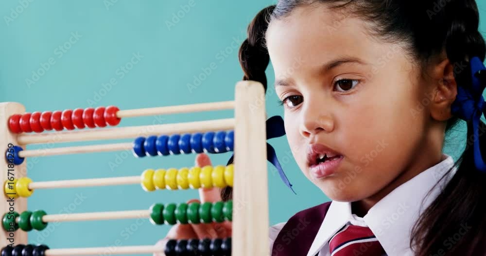 Cute little girl counting on abacus
