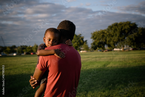 dad carries child to car 