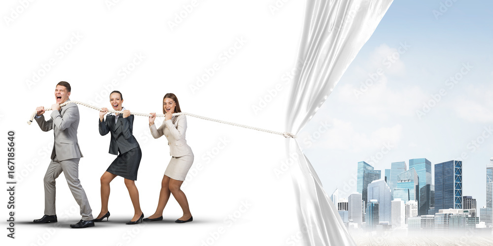 Obraz premium Young businesspeople working in collaboration and pulling white advertisement banner