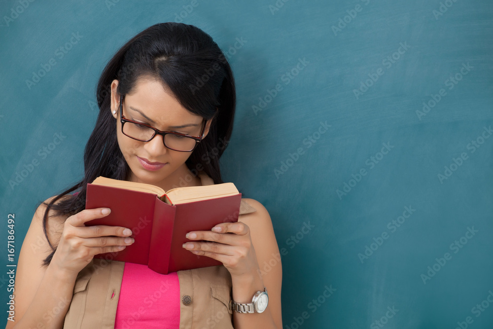 Female college student reading a book Female college student reading a book