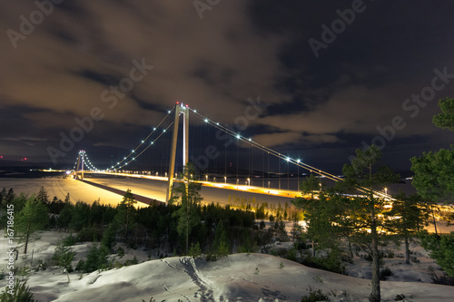 Night shot of bridge in winter above frozen river