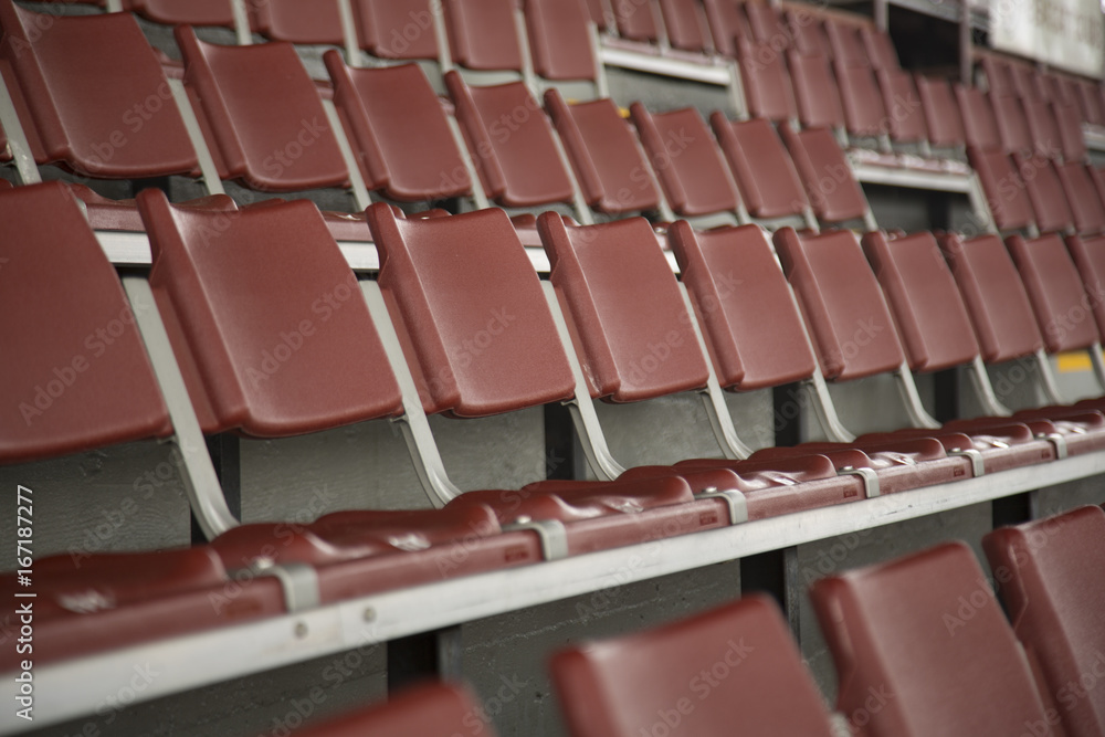 Rows of Empty Rust Colored Amphitheater Stadium Seats, Side Point of View 