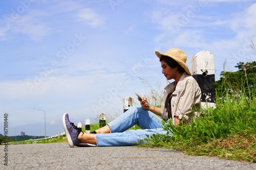 Woman is sitting at roadside