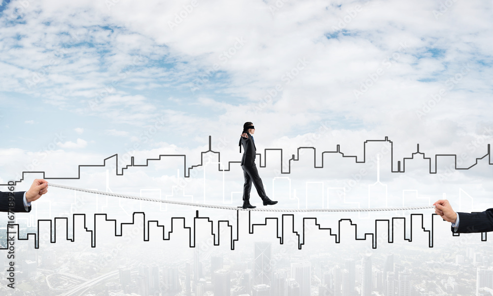 Business concept of risk support and assistance with man balancing on rope Business concept of risk support and assistance with man balancing on rope
