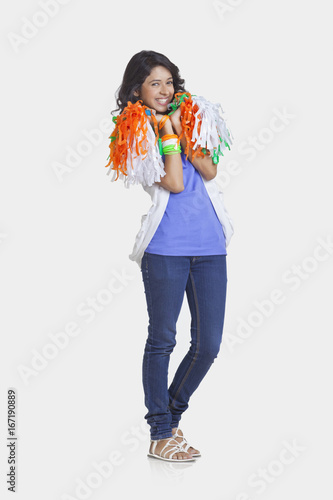 Photography Full length portrait of young female in casual wear holding Indian tricolor pom