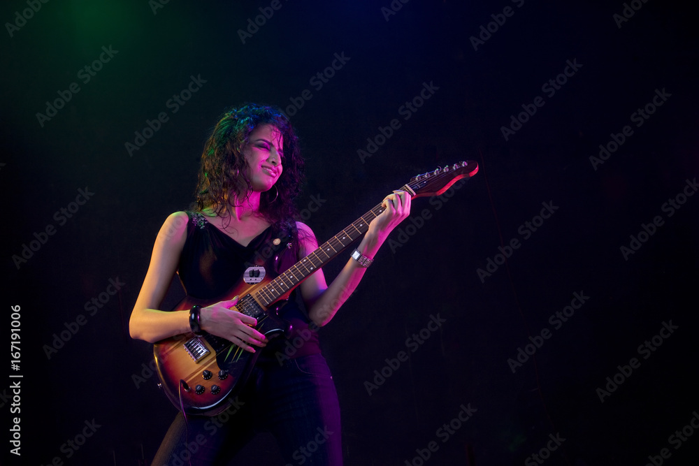 Young woman playing the guitar 