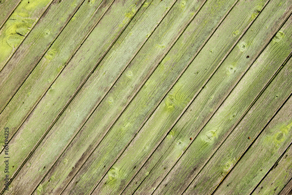 Ancient wood with cracked paint of green color Ancient wood with cracked paint of green color