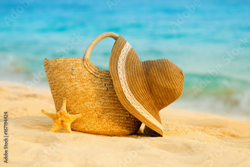 Summer beach with accessories. Blur azure sea on background