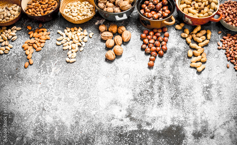 A lot of nuts in different bowls. A lot of nuts in different bowls.