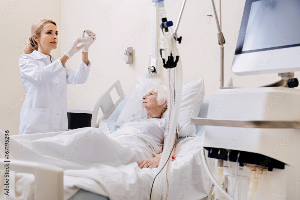 Scrupulous competent doctor injecting the cure Scrupulous competent doctor injecting the cure