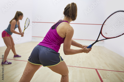 Women playing racket sport indoors © gpointstudio