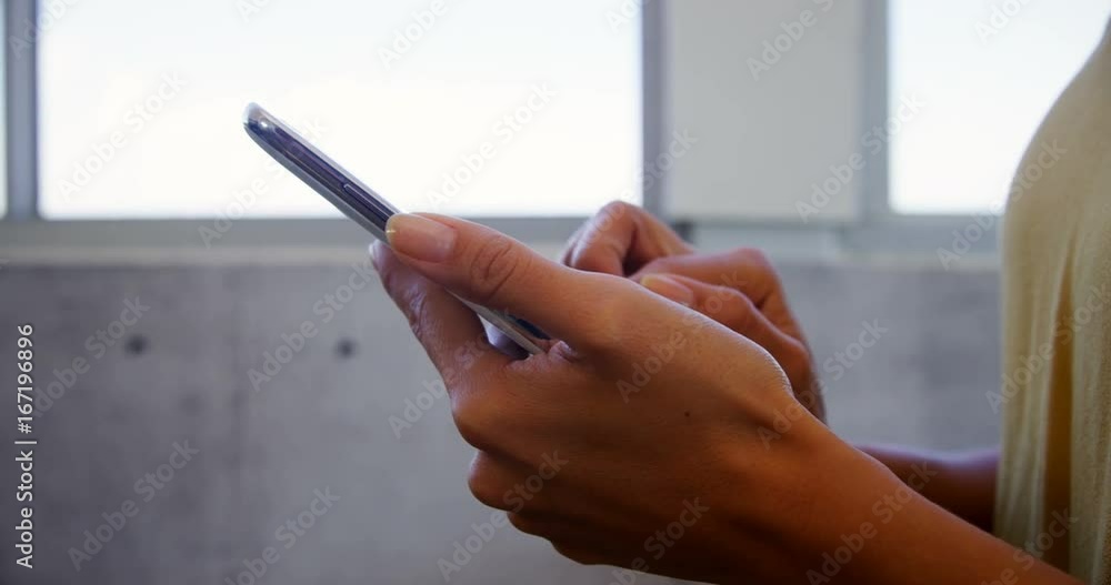 Executive using mobile phone in office Executive using mobile phone in office