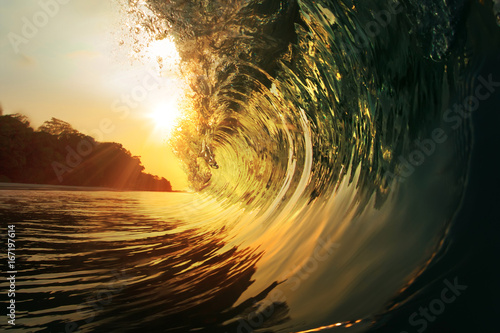 Принти на полотні rough colored ocean wave falling down at sunset time
