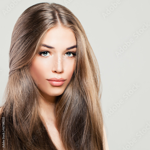 Beautiful Woman with Long Brown Hair. Makeup, Hairstyle and Cute Face. Fashion Portrait