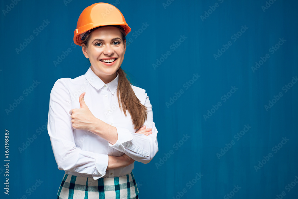 Smiling woman architect wearing building helmet thumb up showing. Smiling woman architect wearing building helmet thumb up showing.