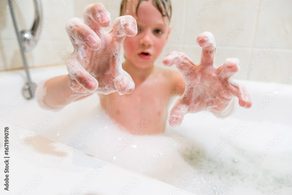 Fototapeta premium a child playing in a bubble bath at home