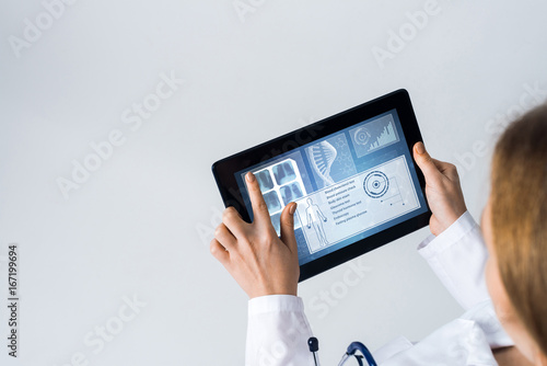 Close of female doctor hands working with tablet pc computer