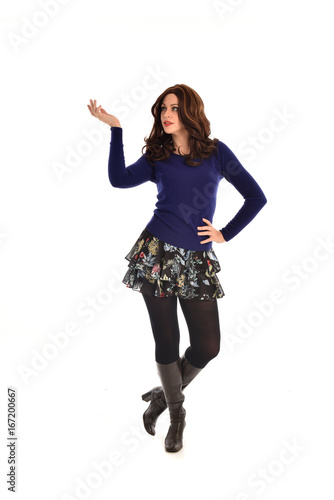 Full length portrait of a brunette girl wearing casual modern clothes. standing pose, isolated against white background